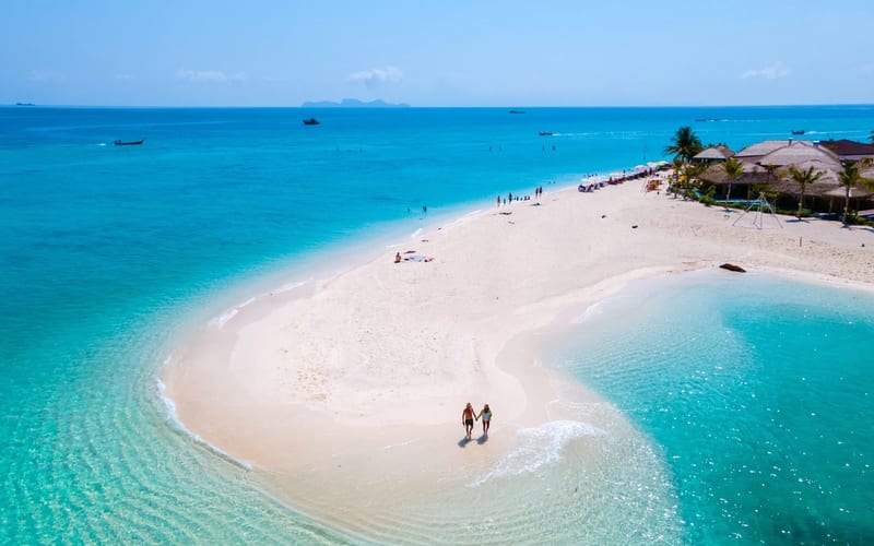 Couple relaxing on a honeymoon beach holiday