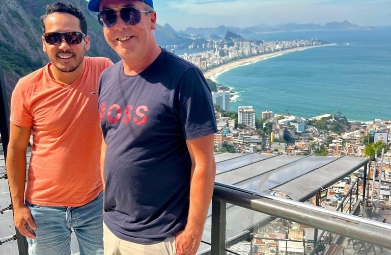 Two travellers at a coastal viewpoint in Brazil