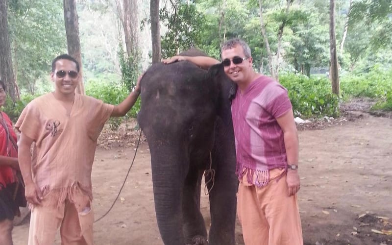 Two travellers with an elephant in the Thai forest